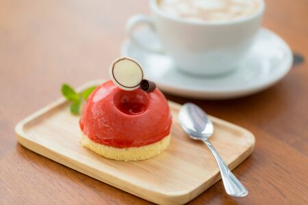 Strawberry cake on wood plate