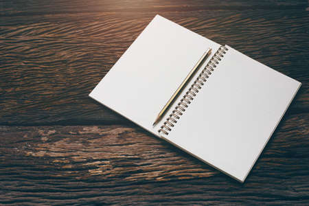open note book with pencil on wood backgroundの写真素材