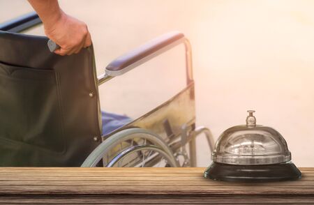 Hospital bell vintage with wheelchair background