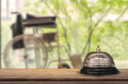 Hospital bell vintage with wheelchair blurred backgroundの写真素材