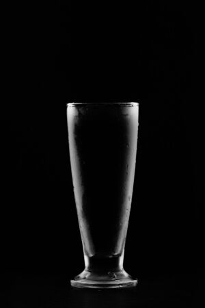 Empty glass cold isolated on darkの写真素材