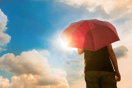 Umbrella under sunshine with travellerの写真素材