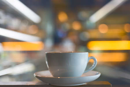 Coffee cup with bokeh  in coffee shop - vintage styleの写真素材