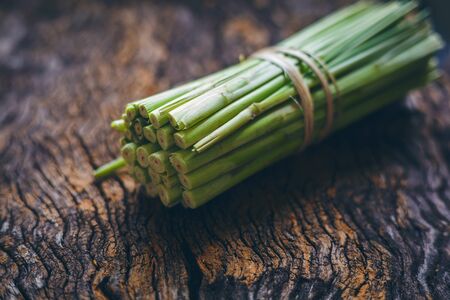Fresh lemongrass (citronella) on wooden background - Spice for health.