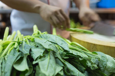 Chef preparing vegetable for cooking in kitchen