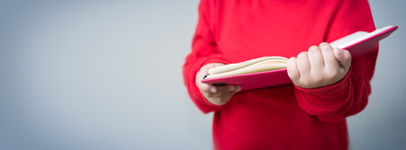 Young boy reading with copy spaceの写真素材