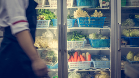 Refrigerator with vegetable in kitchenの写真素材