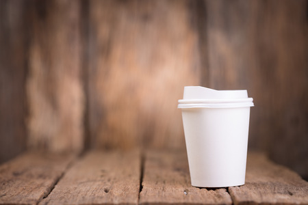 Paper coffee cup on wooden backgroundの写真素材