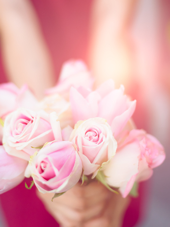 Sweet Rose bouquet on girl handの写真素材