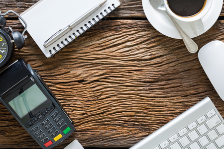 Wood office desk table with laptop, cup of coffee and credit businessの写真素材