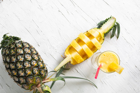 Smoothie pineapple with glass on white rough backgroundの写真素材