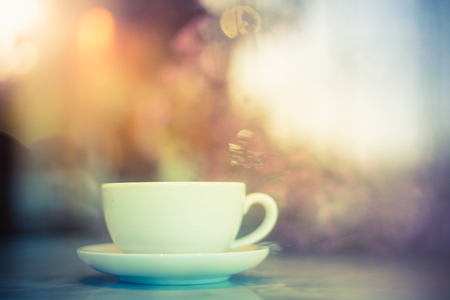 Coffee cup with rain water on glassの写真素材