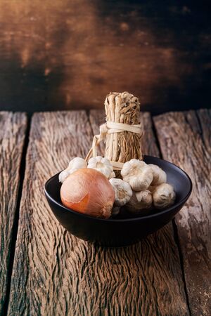 Still life with onions and garlics on woodenの写真素材