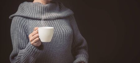 Woman holding cup of coffeeの写真素材