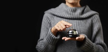 Call bell for service on hand âs womanの写真素材