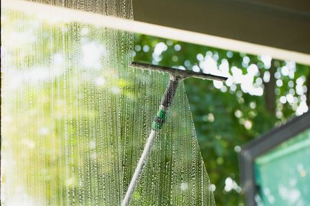 Cleaning window pane with glass cleaner. Cleaning glass conceptの写真素材