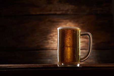 Glass beer on wood background with copy spaceの写真素材