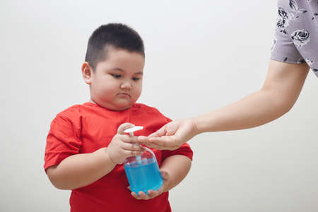 Asia Boy holding bottle with antiseptic cleaning gel. Prevent the virus and bacterias