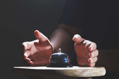 Bell on counter for service with hand backgroundの写真素材