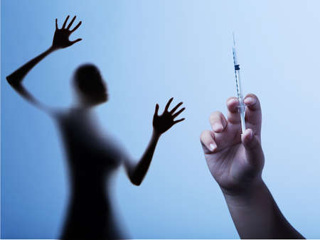 Woman is fear and cries from syringe with vaccination doctor,Corona Virus 19 conceptの写真素材