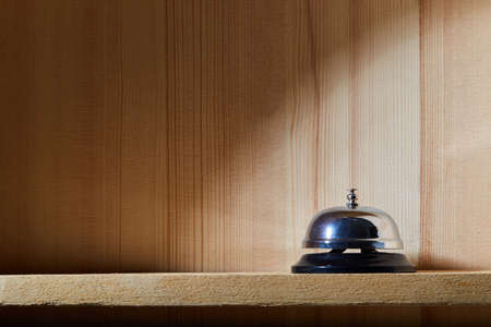 Bell on counter for service with wooden backgroundの写真素材