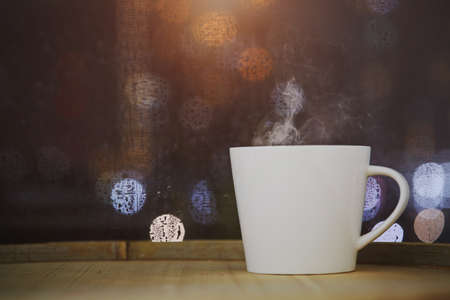 Cup of coffee on wood with bokeh backgroundの写真素材