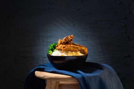 Still life with Baked Pork Ribs Rice on dark backgroundの写真素材