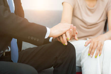 Professional psychiatrist hands together holding palm of her patientの写真素材