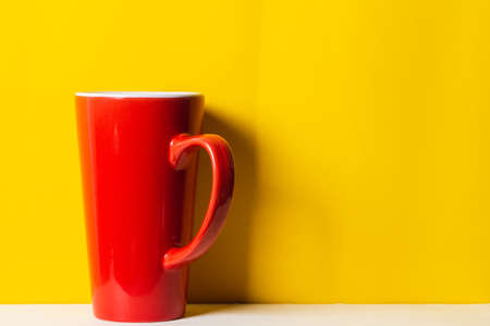 Red cup on yellow backgroundの写真素材