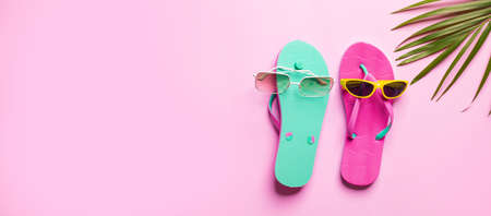 Summer background , Flip flop with palm branch  on pink background, space for textの写真素材