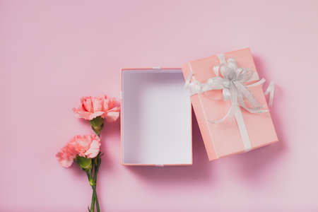 Gift box open with carnation flowers, Mother's Day and Valentines Day conceptの写真素材