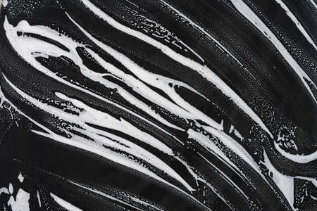 Foam and soap on black background. Glass Cleanerの写真素材