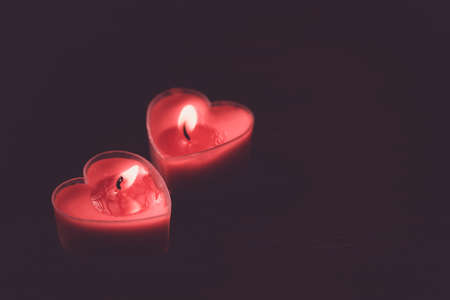 Couple heart is candles on dark backgroundの写真素材