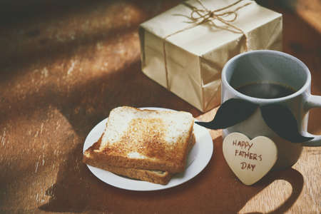 Happy  fathers day with heart and coffee cup on wood