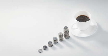Coins stack with a coffee cup with copy-space. Business conceptの写真素材