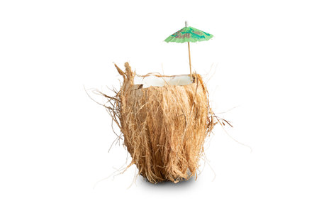 Cracked coconut with umbrella summer on bright background. Summer tropical concept. Photo with Clipping pathの写真素材