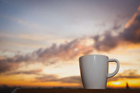 Good morning sunrise with coffee cup on the cityの写真素材