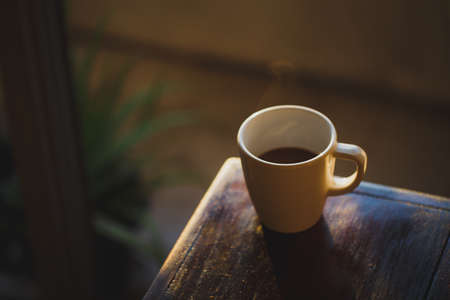 Coffee cup with light and shadow on old wood, Morning with coffeeの写真素材