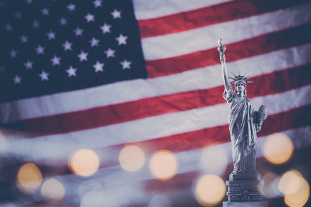 Statue of Liberty on the background of flag usa with bokehの写真素材