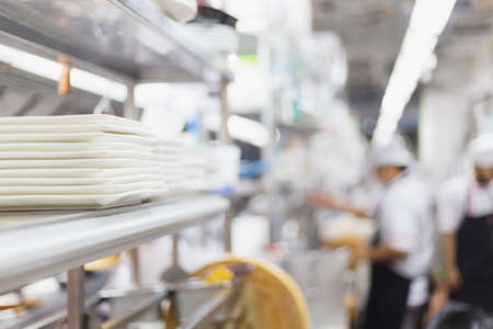 Blurred chefs of a restaurant kitchen backgroundの写真素材