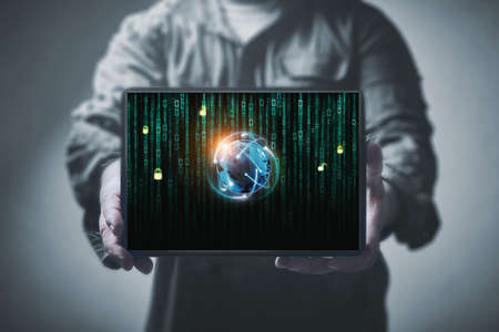 Tablet with globe on binary screen the hands of men. Anti-hacker conceptの写真素材