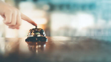 Bell on counter for service with hand. Ring the bellの写真素材