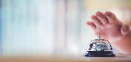 Bell on counter for service with hand. Ring the bellの写真素材