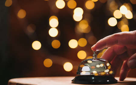Bell service on counter wiith hand, Bell call for service with bokeh backgroundの写真素材