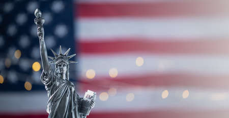 Statue of Liberty on the background of flag usa with bokehの写真素材