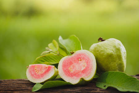 Guava sliced on wood table with green natural backgroundの写真素材