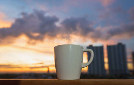 Good morning sunrise with coffee cup on the cityの写真素材