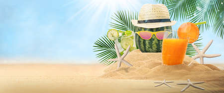 Water melon with hat, Travel background concept. Empty sand with hat and fruit drink on landscape beach blurred backgroundの写真素材