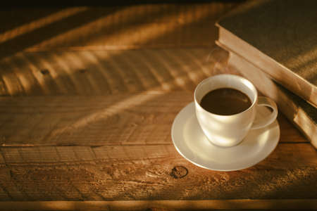 Coffee cup with light and shadow on old wood, Morning with coffeeの写真素材