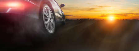 Sport car wheel drifting on night of city lighting backgroundの写真素材